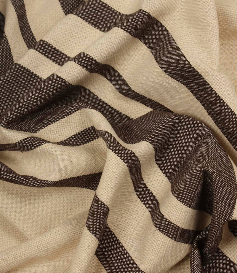 Softly draped brown stripe fabric with wide and narrow stripe detailing on a natural background.