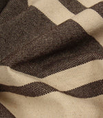 Detailed close-up of woven brown stripe fabric highlighting the textured weave and rich contrast.