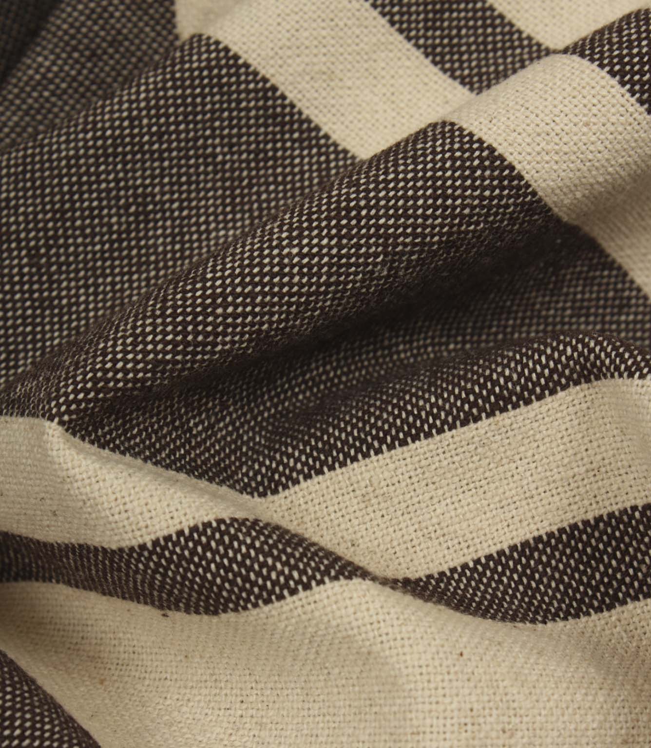 Detailed close-up of woven brown stripe fabric highlighting the textured weave and rich contrast.