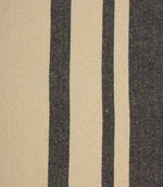 Close-up of charcoal and cream striped woven fabric showing the detailed weave and contrasting stripe pattern.