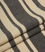 Folded charcoal grey and natural striped fabric with a soft drape and durable woven texture.