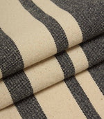 Neutral striped upholstery fabric in charcoal and cream tones with a textured woven surface.