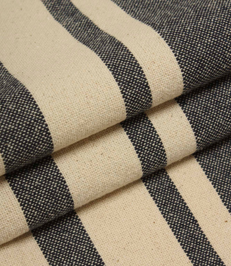 Neutral striped upholstery fabric in charcoal and cream tones with a textured woven surface.