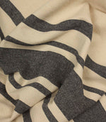 Softly draped charcoal stripe fabric featuring wide and narrow stripes on a natural background.
