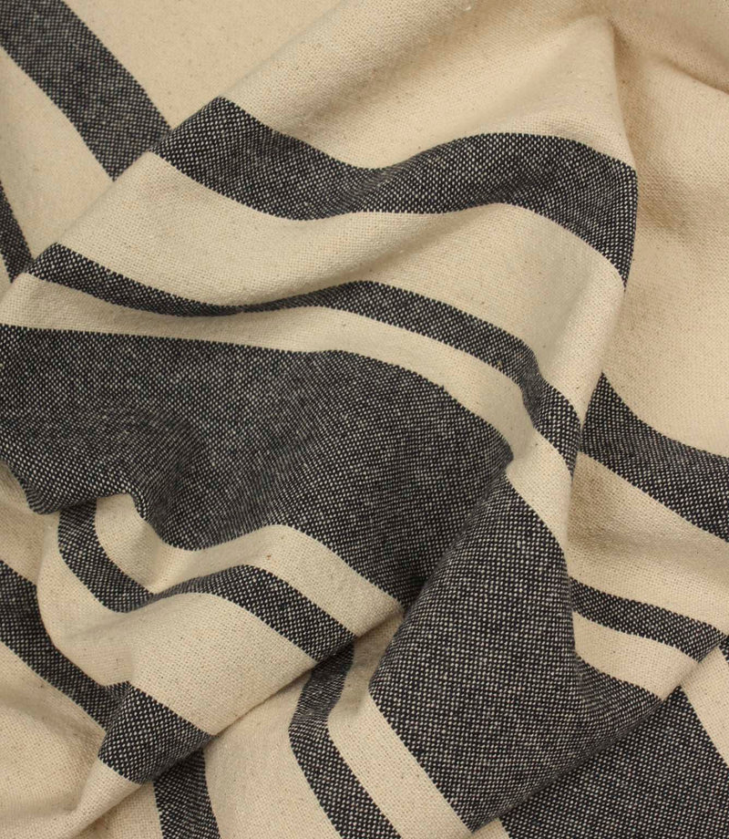 Softly draped charcoal stripe fabric featuring wide and narrow stripes on a natural background.