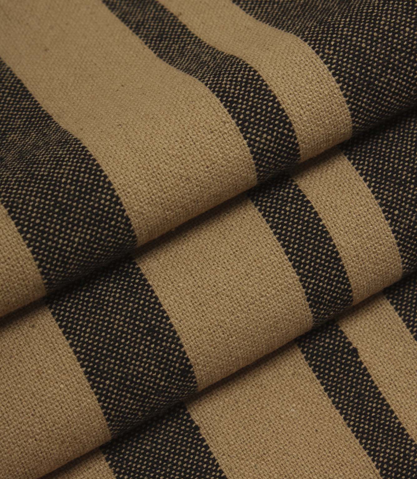 Neutral striped upholstery fabric in camel and black tones with a textured woven surface.