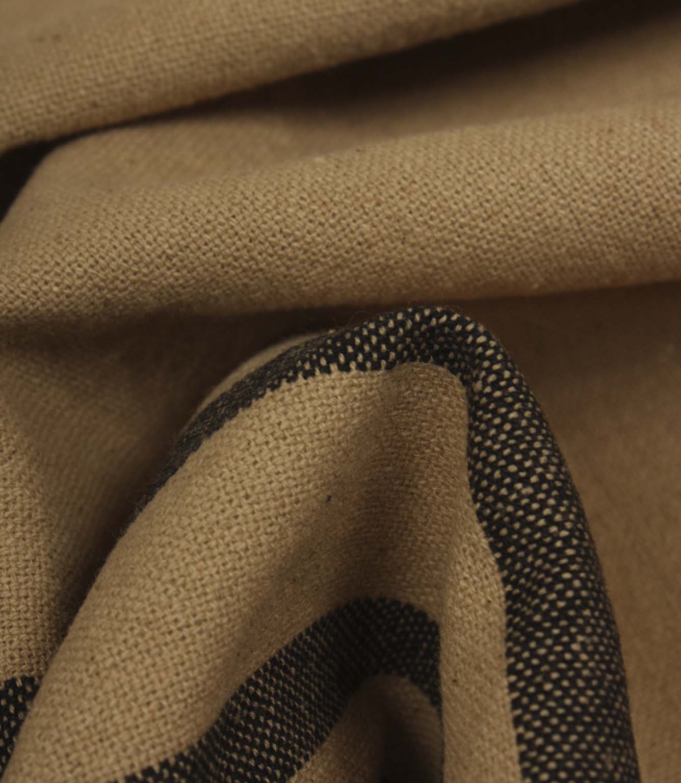 Detailed close-up of woven black stripe fabric showing the textured weave and rich contrast.