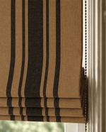 Brown and black striped roman blind against a white wall