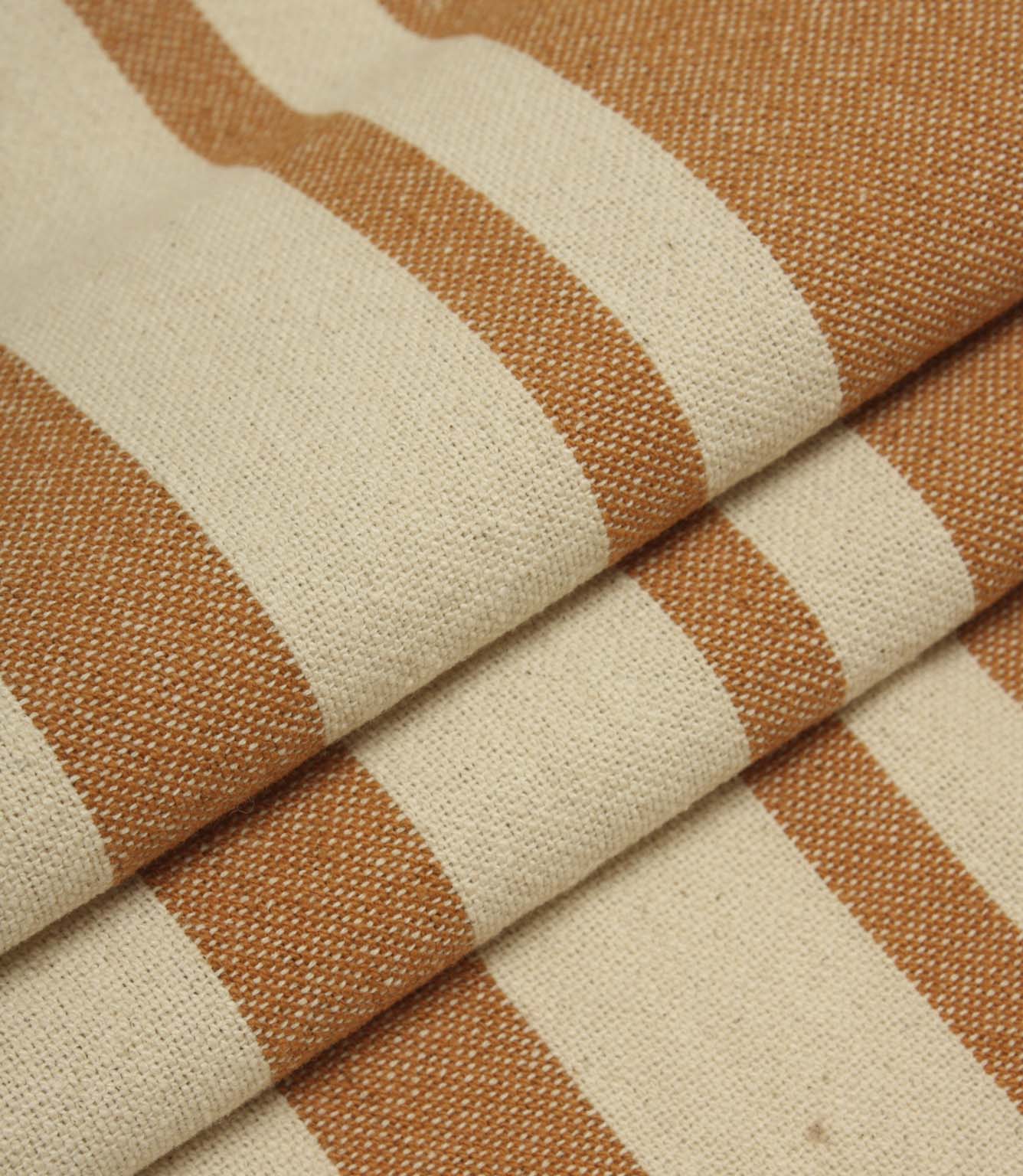 Gathered cream and terracotta striped fabric highlighting the bold stripe design and relaxed woven texture.