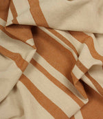 Detailed close-up of cream and terracotta woven stripe fabric showing the contrast and texture within the weave.