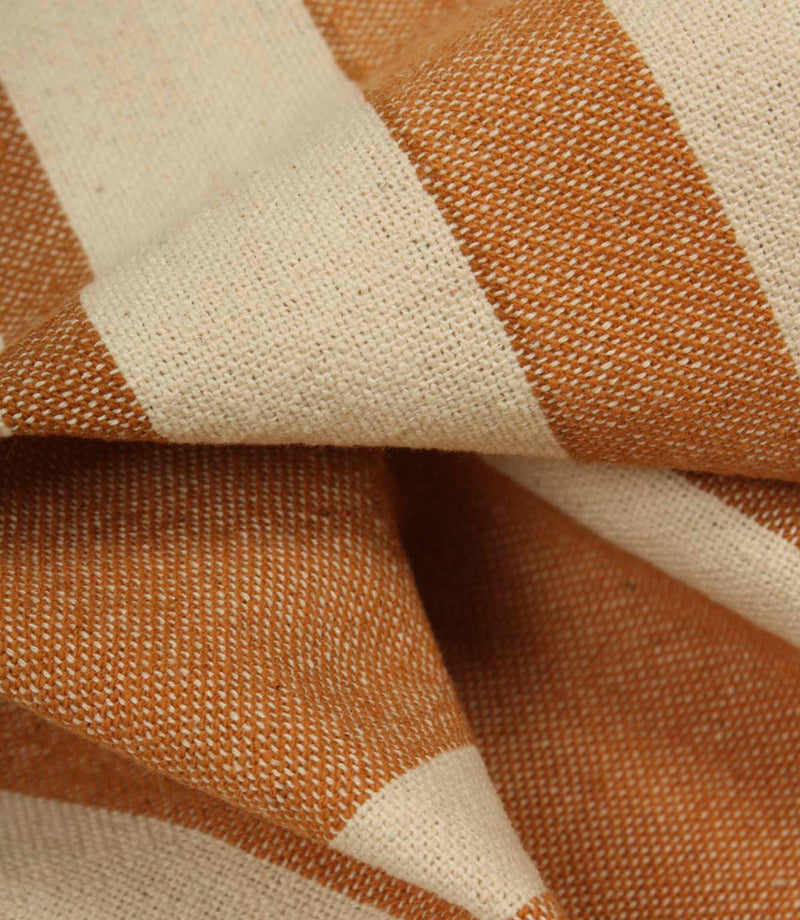Rolled cream striped fabric with terracotta stripe detailing, suitable for upholstery, curtains and interior décor applications.