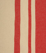 Close-up of cream fabric with vibrant red woven stripes highlighting the detailed texture and stripe spacing.