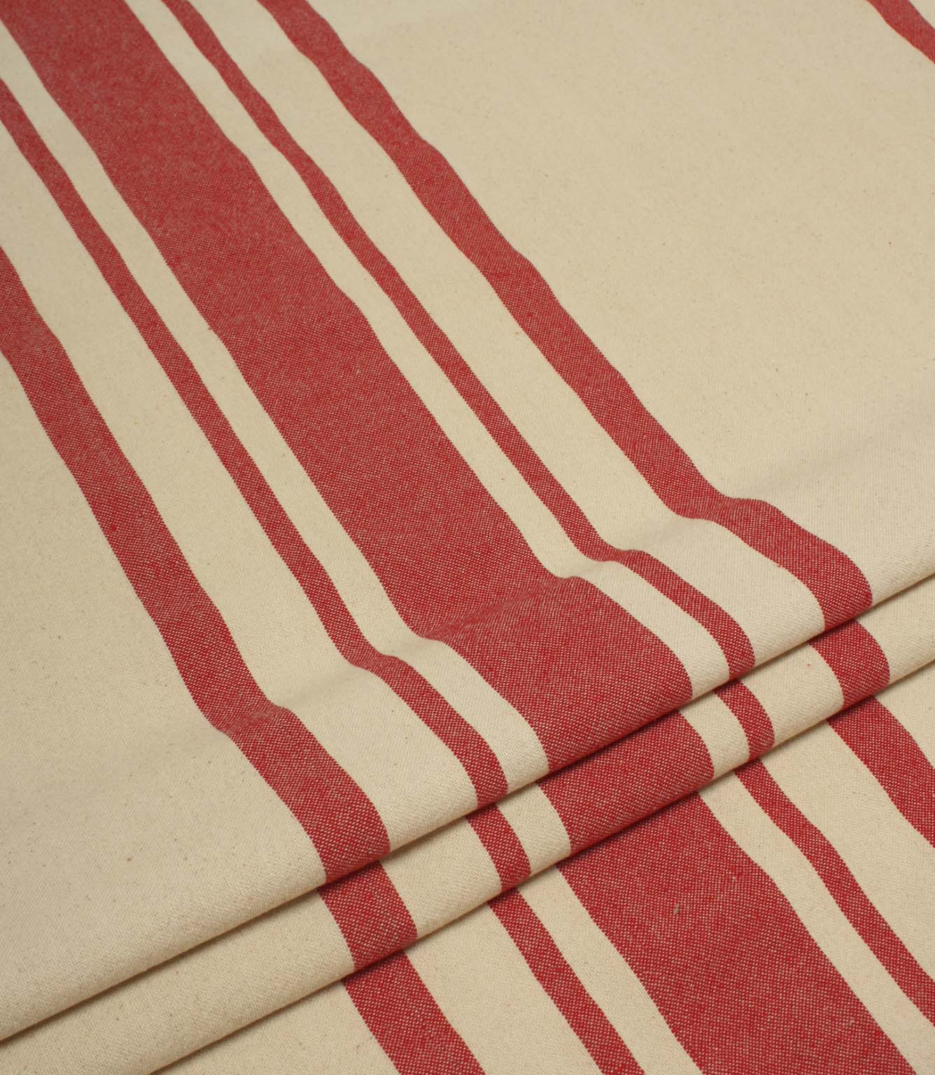 Folded cream and red striped upholstery fabric showing the bold stripe pattern and soft woven drape.