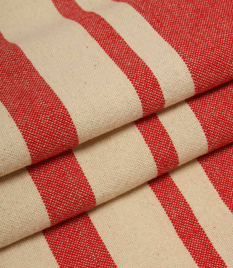 Detailed close-up of folded cream and red striped fabric with textured weave and contrasting stripe design.