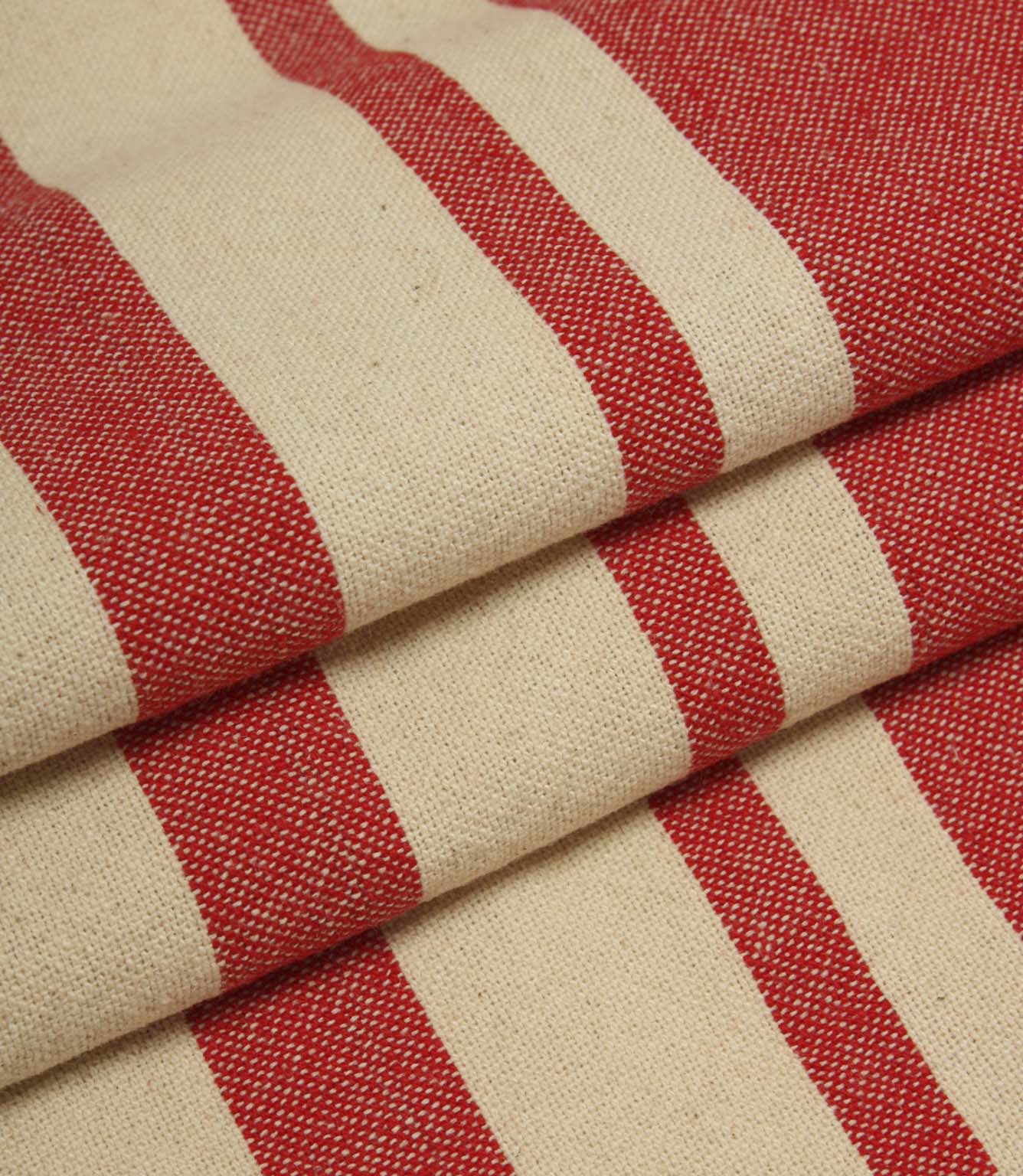 Detailed close-up of folded cream and red striped fabric with textured weave and contrasting stripe design.