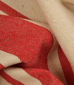 Macro close-up of cream and red woven stripe fabric showing the fine weave detail and soft texture.