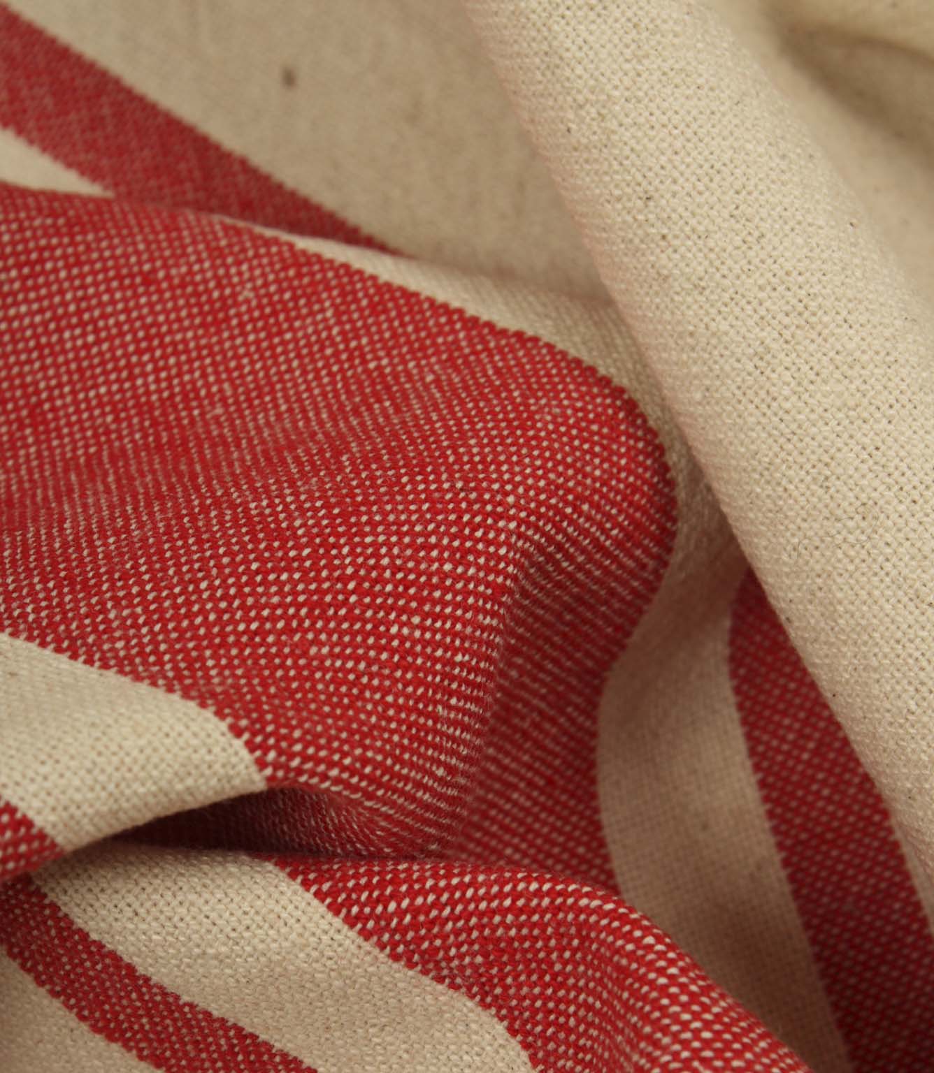 Macro close-up of cream and red woven stripe fabric showing the fine weave detail and soft texture.