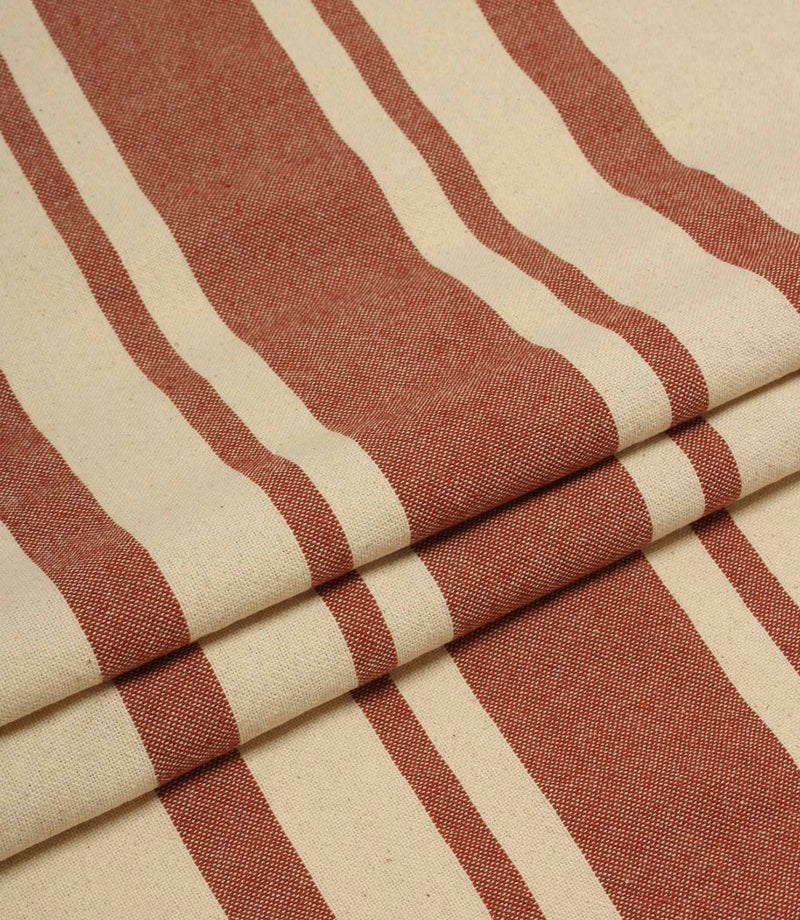 Folded cream and terracotta striped upholstery fabric showing the bold stripe repeat and soft woven drape.