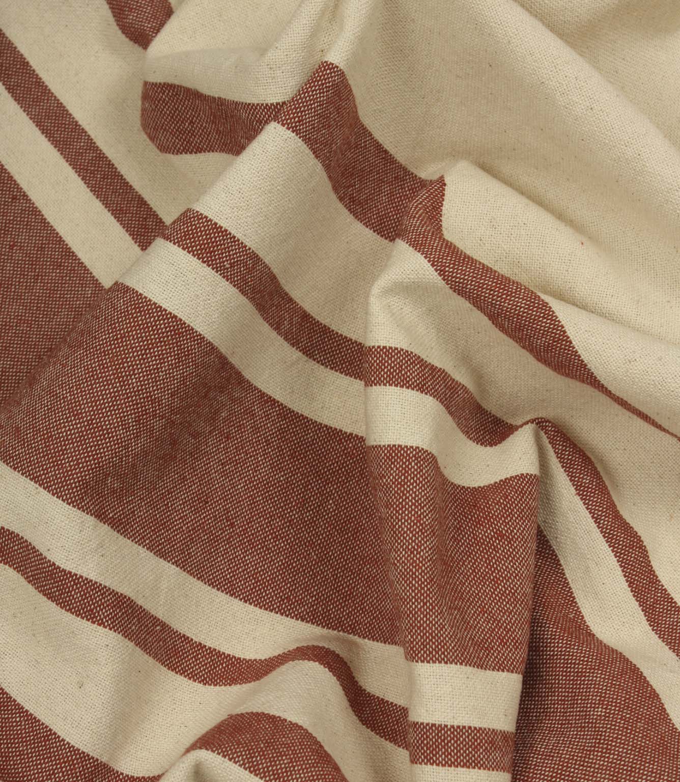 Gathered cream and terracotta striped fabric highlighting the soft drape and relaxed woven texture.