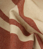 Macro close-up of cream and terracotta woven stripe fabric showing the fine weave detail and tactile finish.