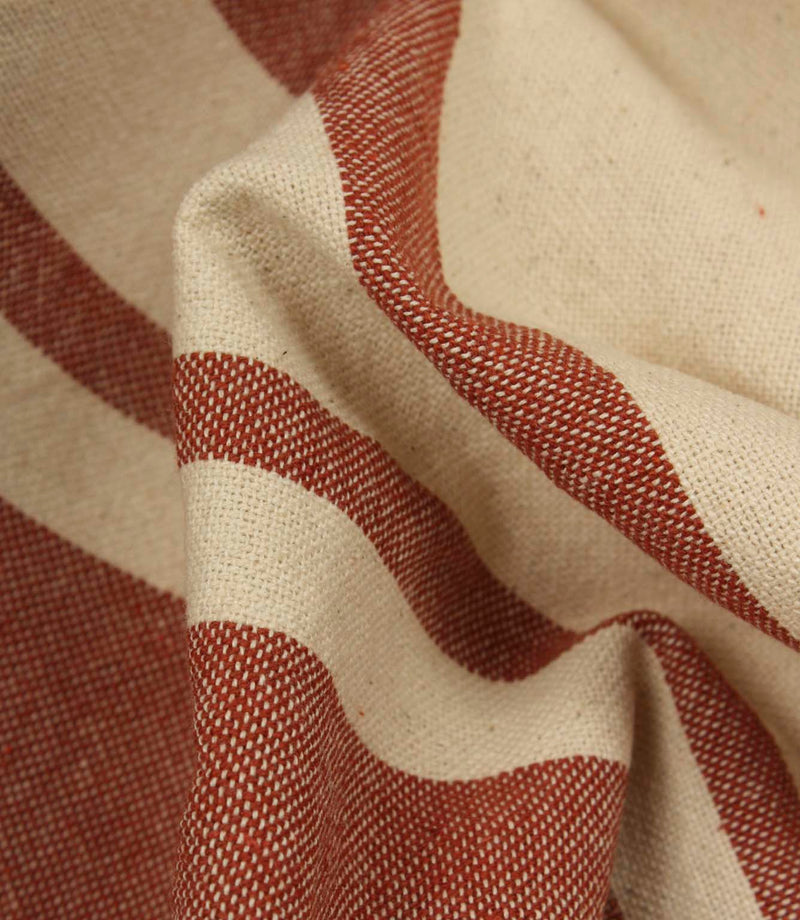 Macro close-up of cream and terracotta woven stripe fabric showing the fine weave detail and tactile finish.