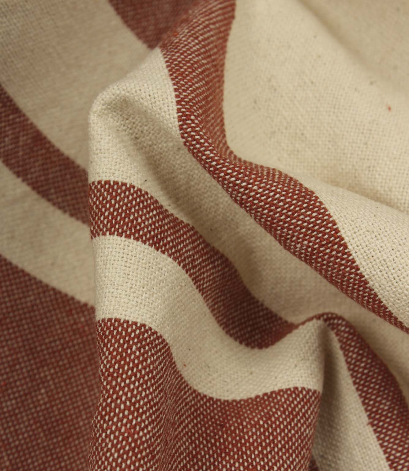 Macro close-up of cream and terracotta woven stripe fabric showing the fine weave detail and tactile finish.