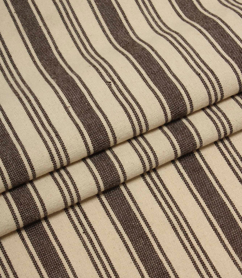 Folded cream and brown striped upholstery fabric showing the repeating stripe pattern and soft woven texture.