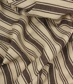 Gathered cream and dark brown striped fabric highlighting the relaxed drape and timeless woven stripe design.