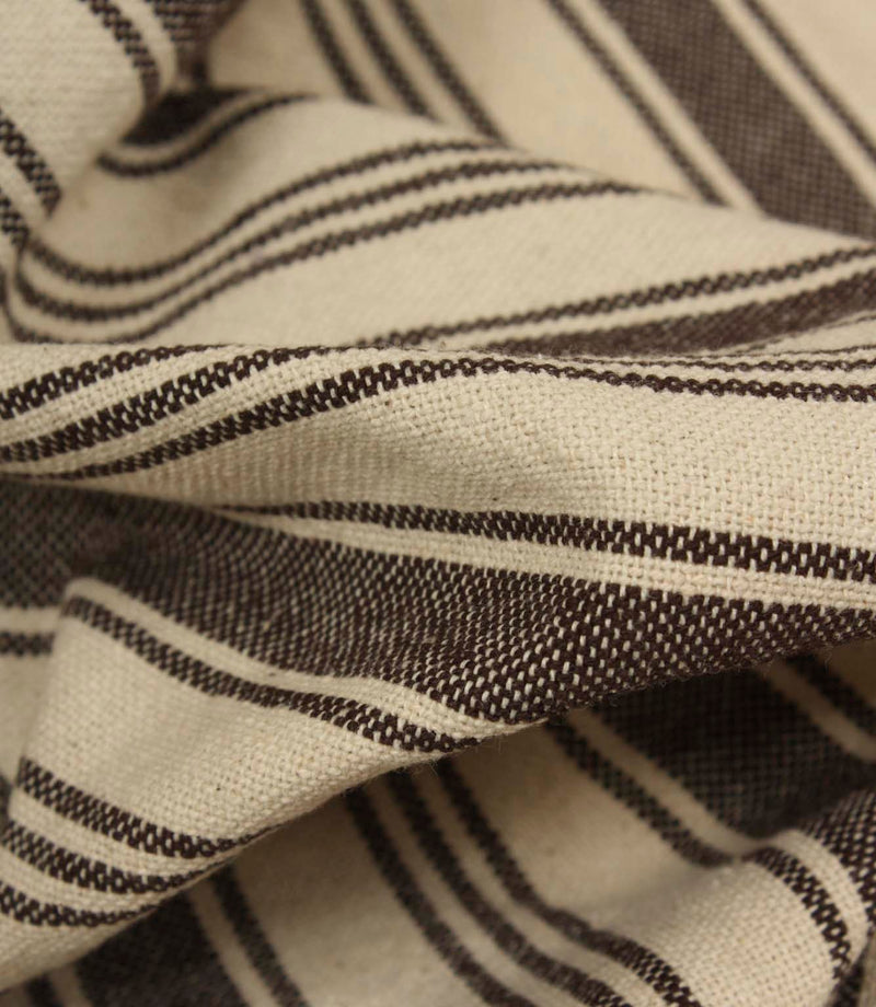 Macro close-up of cream and brown striped woven fabric showing the tactile texture and fine stripe detailing.