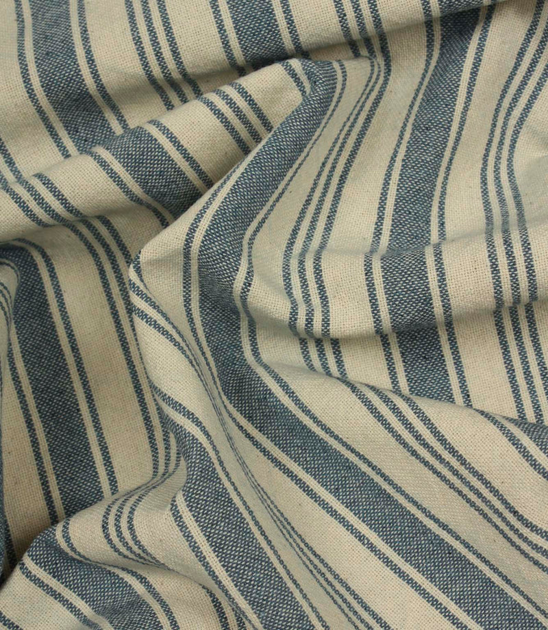 Softly gathered denim-blue striped fabric displaying the relaxed drape, woven texture, and timeless country-style stripe design.