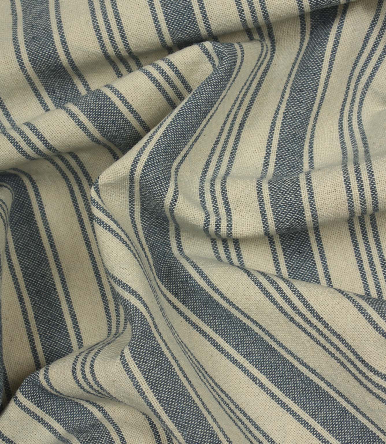 Softly gathered denim-blue striped fabric displaying the relaxed drape, woven texture, and timeless country-style stripe design.