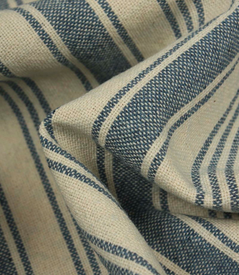 Detailed close-up of woven blue ticking stripe fabric, highlighting the textured upholstery weave and natural linen-look finish.