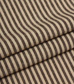 Folded striped fabric in dark brown and cream tones highlighting the soft woven finish.