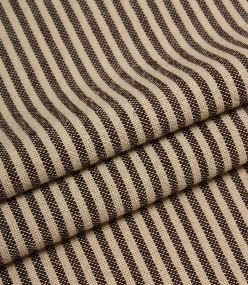 Folded striped fabric in dark brown and cream tones highlighting the soft woven finish.