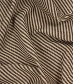 Draped brown and ivory striped fabric showing fluid movement and textured weave detail.