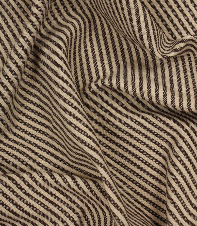 Draped brown and ivory striped fabric showing fluid movement and textured weave detail.
