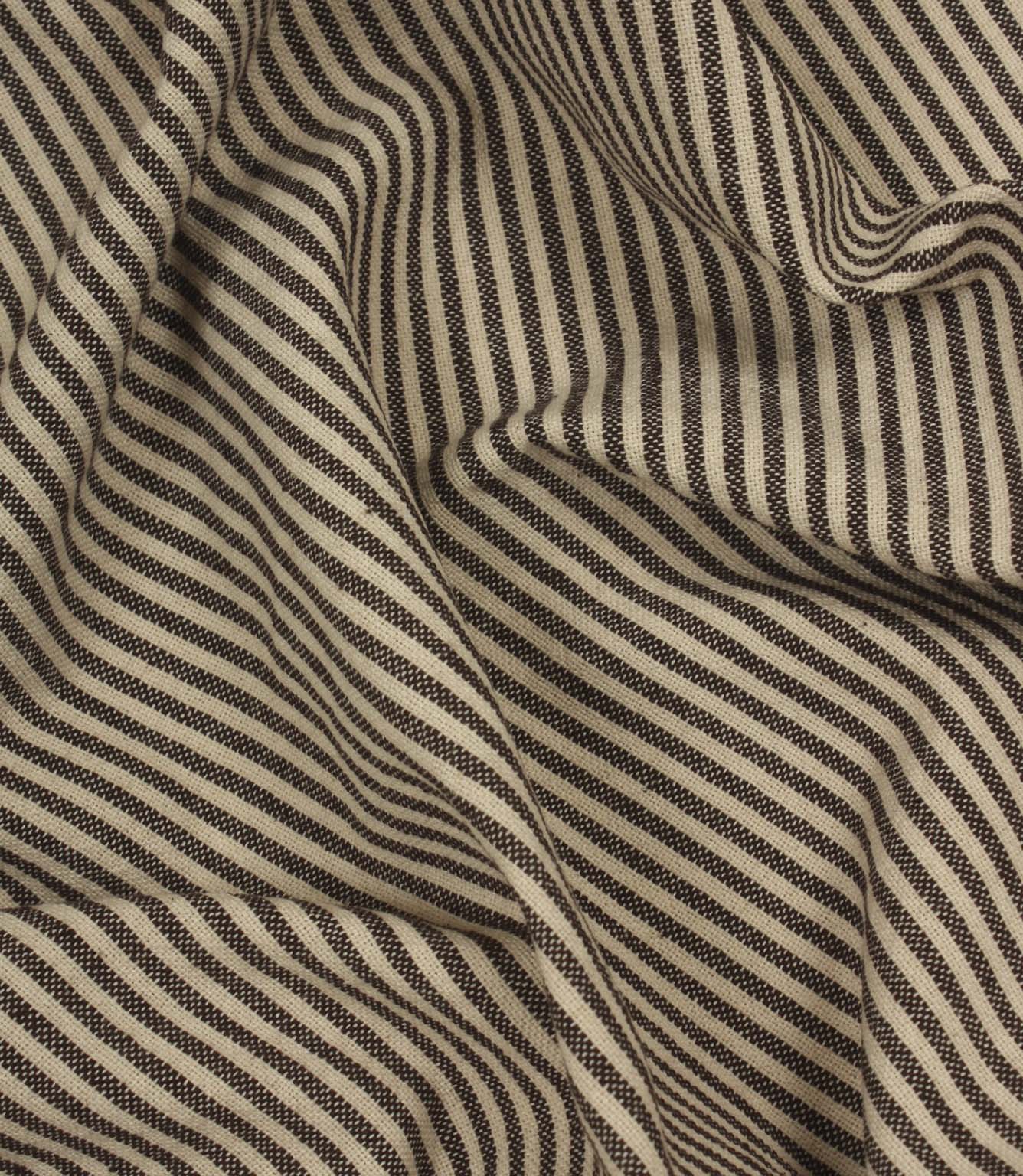 Draped brown and ivory striped fabric showing fluid movement and textured weave detail.