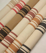 Coordinated collection of wide-striped furnishing fabrics with textured woven finishes, presented in a range of warm neutral and contemporary colour combinations.
