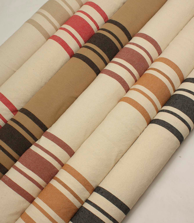 Coordinated collection of wide-striped furnishing fabrics with textured woven finishes, presented in a range of warm neutral and contemporary colour combinations.