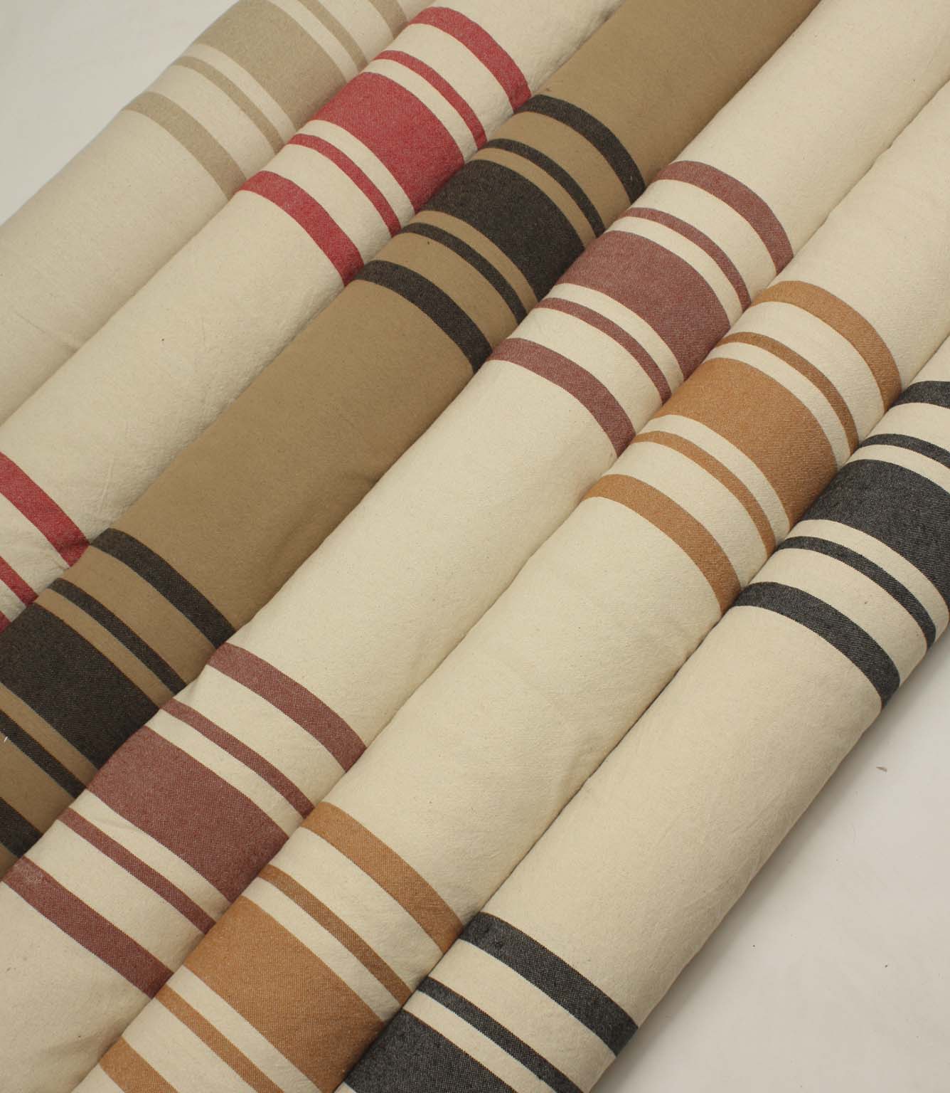 Coordinated collection of wide-striped furnishing fabrics with textured woven finishes, presented in a range of warm neutral and contemporary colour combinations.
