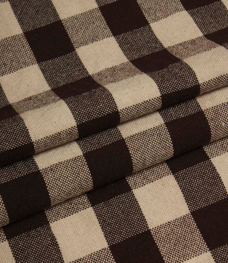 Folded gingham fabric in rich brown and cream tones showing the structured woven pattern.