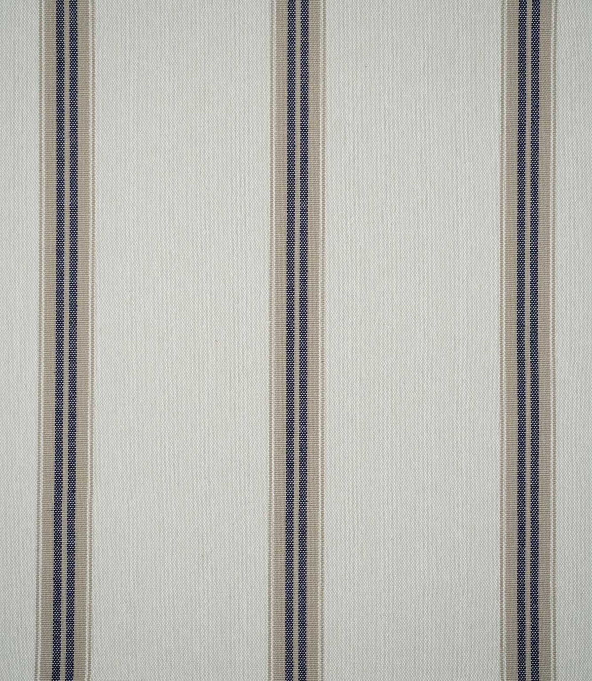 Alma Stripe Marina woven fabric featuring widely spaced navy blue and natural beige vertical stripes on a warm off-white background.