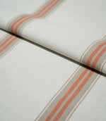Folded Alma Stripe Terracotta fabric showing the off-white woven ground with repeating terracotta and natural beige stripes and a tactile textured finish.