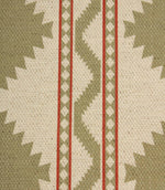 Close-up of sage and cream geometric fabric showing textured woven detail, featuring tribal-style diamond shapes and red accent stripes.