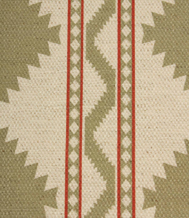 Close-up of sage and cream geometric fabric showing textured woven detail, featuring tribal-style diamond shapes and red accent stripes.