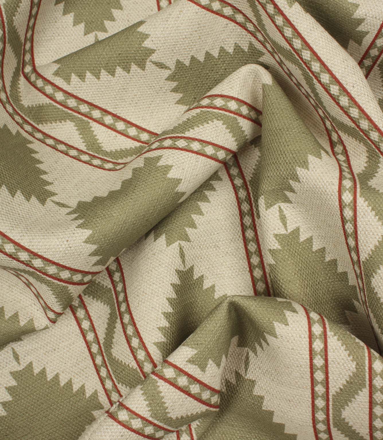 Softly gathered sage and cream geometric upholstery fabric displaying the woven texture, natural drape, and decorative Southwestern-inspired motif.