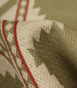 Detailed close-up of sage green patterned fabric revealing the textured weave, natural linen-look finish, and fine red stripe detailing.