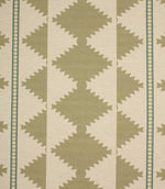 Patterned fabric with green geometric design on a beige background