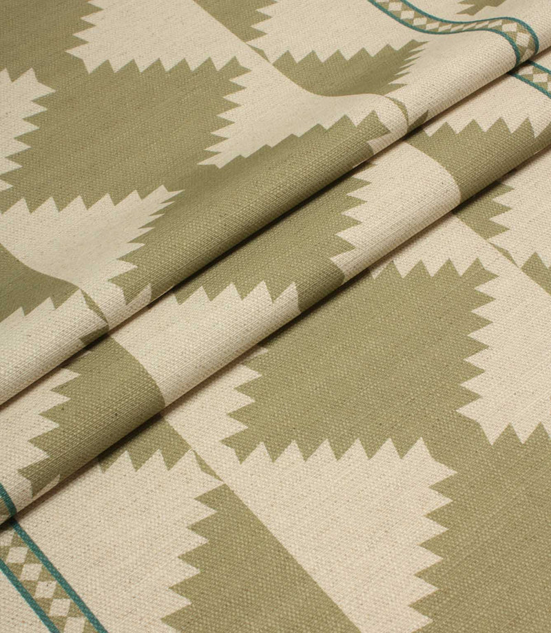Folded fabric with geometric pattern in green and beige tones