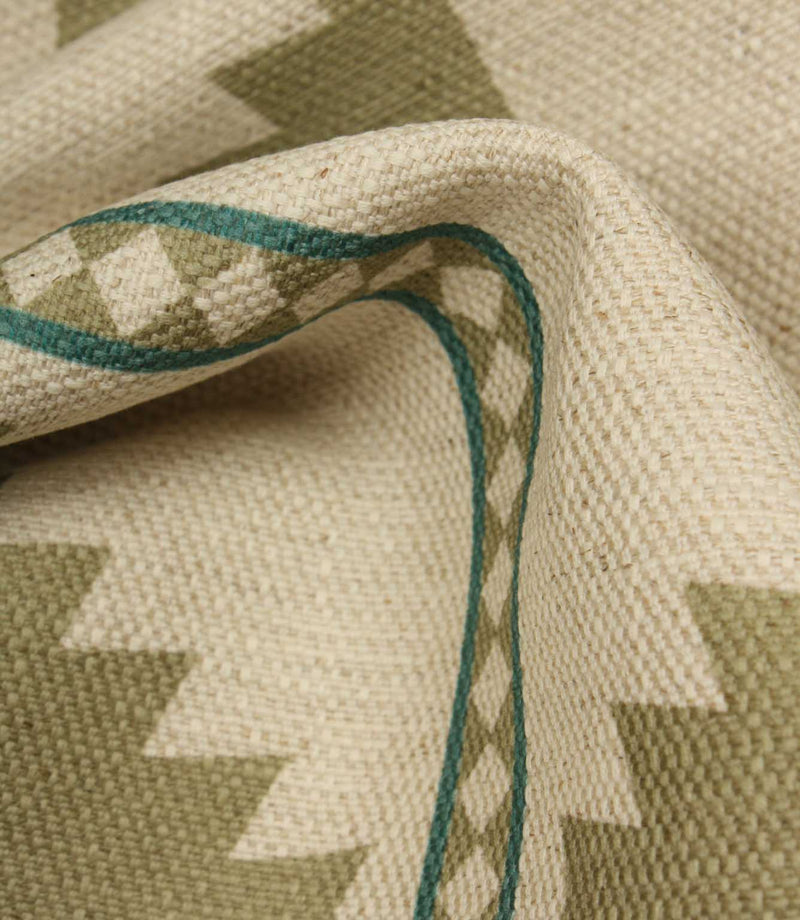 Close-up of a woven fabric with geometric pattern and green thread